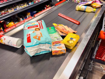 Téléchargez les photos : Allemagne - 4 mars 2023 : Une gamme diversifiée de produits d'épicerie et de garde-manger frais remplit le comptoir du supermarché allemand. Une véritable scène d'approvisionnement et de variété pour le shopping hebdomadaire. - en image libre de droit