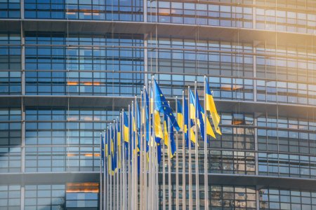 Photo for 24 Ukrainian flag flies next to the Flag of Europe in front of Parliament building offices. Russia continues its assault on Ukraines major cities a week after launching a large-scale invasion of the - Royalty Free Image