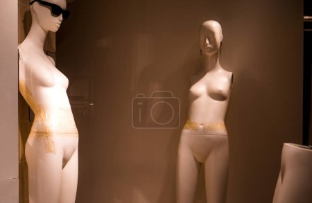 Photo for Captivating abandoned boutique display with female figures, mannequins, and stylish merchandise. Isolated retail window showcases fashion allure. - Royalty Free Image