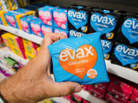 Photo for Mallorca, Spain - Jun 28, 2023: POV male hand confidently purchased female hygiene products manufactured by Evax cottonlike, super alas - Royalty Free Image