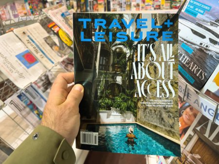 Photo for London, United Kingdom - 21 Apr 2023: A POV male hand holds a travel and leisure magazine cover with exciting travel experiences. Perfect for those seeking leisure and adventure. - Royalty Free Image