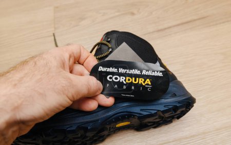 Photo for Hamburg, Germany - Feb 16, 2022: Reading about Cordura Fabric on the new Safety shoes S3 HRO WR SRC Hydro Modytex high black - durable, versatile and reliable - Royalty Free Image