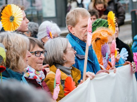 Téléchargez les photos : Strasbourg, France - 29 mars 2023 : point de vue latéral d'un groupe de personnes âgées suisses déterminées qui protestent pacifiquement devant la Cour européenne des droits de l'homme, portant des pancartes alors qu'elles réclament une action contre le changement climatique - en image libre de droit