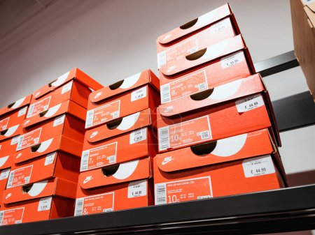 Photo for Roppenheim, France - July 11, 2023: Low angle view of stack with red Nike Air Max Excee TD diverse sizes sport shoes with price of 44.99 euros - Royalty Free Image