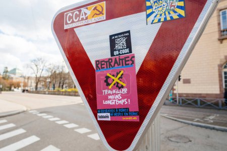 Photo for Strasbourg, France - Mar 20, 2023: Stickers on the street signs left by protesters against Macron government an pension reforms - Royalty Free Image