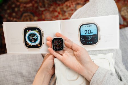 Photo for London, United Kingdom - Sep 28, 2022: POV woman hand holding the package with diverse screens of the new Apple Watch Series Ultra designed for extreme activities like endurance sports - Royalty Free Image