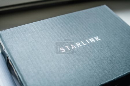 Photo for Frankfurt, Germany - 28 Jul 2023: Close-up of Starlink logotype on the new Ethernet Adapter is designed to connect a device directly to the Starlink router for a wired Internet connection - Royalty Free Image