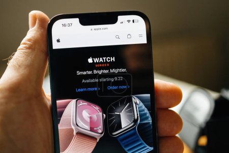 Photo for London, UK - Sep 14, 2023: POV of a male hand holding a smartphone displays Apple Watch Series 9 on Apple.com, emphasizing the Availability Date and Order Now button for immediate purchase. - Royalty Free Image