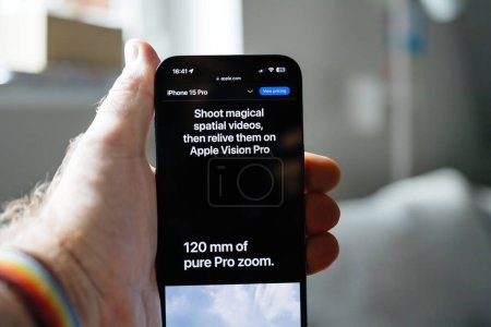 Photo for London, UK - Sep 14, 2023: Apple.com promotes Shoot Magical Spatial Videos, Relive Them on Apple Vision Pro message, emphasizing iPhone 15 PROs state-of-the-art materials, enhanced cameras, and - Royalty Free Image