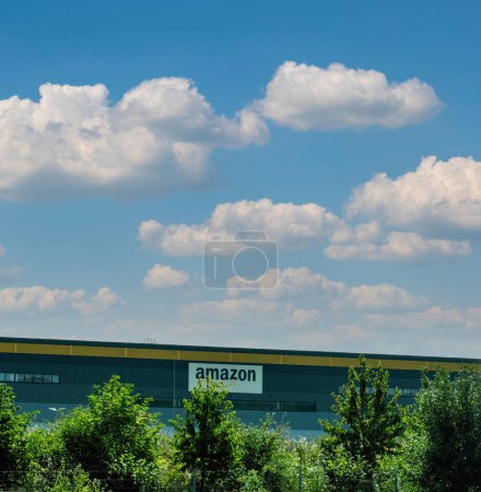 Photo for London, UK - Sep 14, 2023: Square image under a clear sky highlights a large Amazon warehouse, its facade adorned with the companys logotype, representing the paradigm of e-commerce. - Royalty Free Image