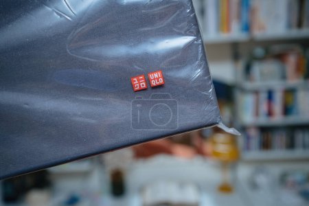 Photo for Paris, France - Jul 5, 2023: The Uniqlo logotype is prominently displayed on the packaging of a fitted sheet, indicating the brands identity and suggesting a focus on quality and comfort - Royalty Free Image