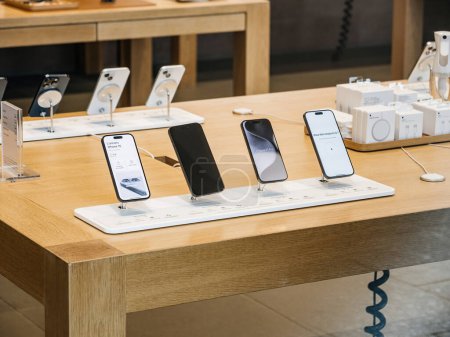 Photo for Paris, France - Sep 22, 2023: As part of the days launch activities, a carefully curated presentation of iPhone 15, 15 Pro, and 15 Max models is visible from the street, all displayed on a wooden - Royalty Free Image