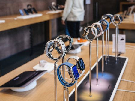 Photo for Paris, France - Sep 22, 2023: The full range of Apple Watches, including the high-end Watch Ultra 2 and Series 9, is prominently displayed as the hero object while customer silhouettes shop in the - Royalty Free Image