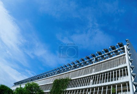 Photo for Low-angle view of a large parking facility featuring solar panels on its rooftop, exemplifying environmentally friendly architecture - Royalty Free Image