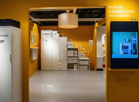 Photo for Paris, France - Aug 31, 2023: Inside an IKEA Swedish furniture store, the Platsa model wardrobe, featuring drawers and shelves, stands on display without customers, accompanied by an LCD screen for - Royalty Free Image