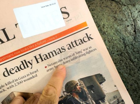 Photo for Paris, France - Oct 9, 2023: In a POV shot, a male hand reads the Financial Times headline: Netanyahu Warns of a Prolonged Conflict - Royalty Free Image