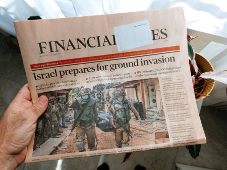 Photo for Paris, France - Oct 11, 2023: POV: Reading Israel Prepares for Ground Invasion - Israel-Palestine Conflict Headline in International Financial Times - Royalty Free Image