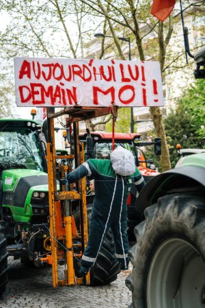 Photo for Strasbourg, France - April 30, 2021: Silhouette of a hanged figure at a farmers protest with tractors in Strasbourg, conveying the message Today Him, Tomorrow Me - Royalty Free Image