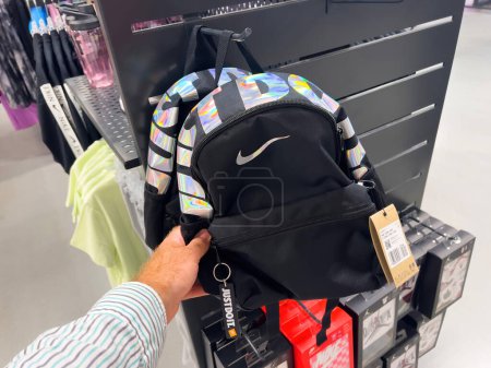 Photo for Roppenheim, France - July 11, 2023: Through a POV perspective, a male hand confidently holds a new Nike backpack rucksack, adorned with the iconic Just Do It logotype and swoosh logo. - Royalty Free Image