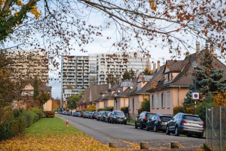 Photo for Strasbourg, France - Nov 22, 2023: The new Wacken business high-rise stands tall against the backdrop of golden-yellow trees, as an alley of cars lines the Rue des Jacinthes street, embodying the fall - Royalty Free Image