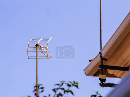 Photo for A telephoto view of an aerial antenna set against a backdrop of violet and white skies, exemplifying the beauty of technology in nature - Royalty Free Image