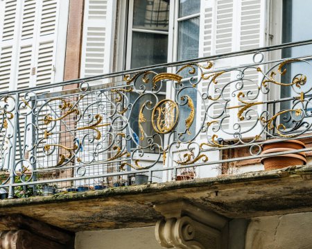 Photo for Telephoto view of a balcony in a French city, featuring a gold-plated and intricately decorated protective fence - Royalty Free Image