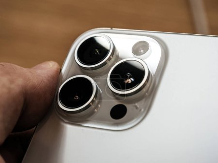 Photo for Paris, France - Sep 22, 2023: Male hand examining the white titanium body of the Apple iPhone 15 Pro Max, featuring a new 5x camera zoom - Royalty Free Image