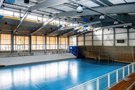 Photo for A spacious college sports hall, featuring mini soccer goals and a clean interior, stands ready to accommodate a variety of sports projects - Royalty Free Image