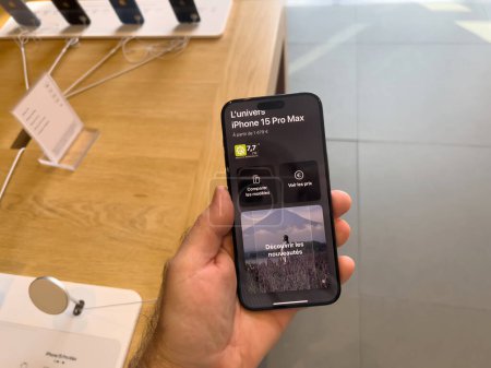 Photo for Paris, France - Sep 22, 2023: a potential buyer tests the capabilities of the latest iPhone 15 Pro inside the Apple Store - Royalty Free Image