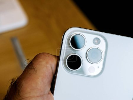 Téléchargez les photos : Paris, France - 22 sept. 2023 : Une main masculine saisit le dernier iPhone 14 Pro Max d'Apple Computers, mettant en valeur son système sophistiqué de triple caméra et son capteur LiDAR avancé - en image libre de droit