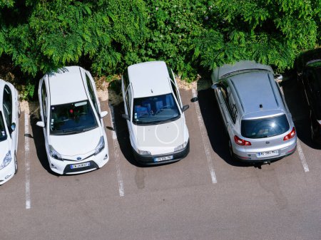Photo for Strasbourg, France - May 5, 2023:An aerial view of a neatly organized outdoor parking lot with various cars parked in designated spaces, surrounded by greenery - Royalty Free Image