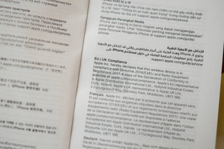 Photo for Paris, France - Oct 25, 2023: A close-up image of the new compliance information sheet from Apple Computers for a smartphone, featuring multilingual texts in French, Arabic, and English - Royalty Free Image
