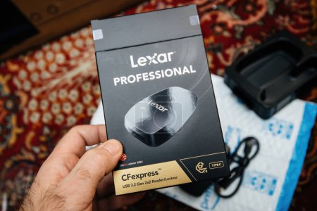 Photo for Strasbourg, France - Dec 12, 2022: A male hand presents the front part of a Lexar CFexpress USB 3.2 Gen 2x2 card reader package during an Amazon Prime unboxing session - Royalty Free Image