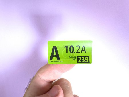Photo for Paris, France - Sep 28, 2023: A green sticker with driver aid instructions for an Amazon Parcel delivery employee, set against a defocused background - Royalty Free Image