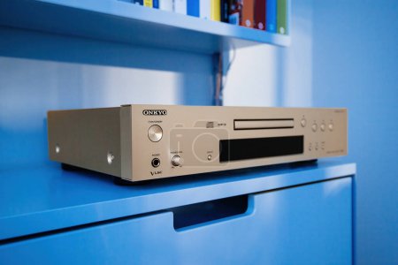 Photo for Frankfurt, Germany - Dec 12, 2022: An Onkyo professional CD SACD player sits on Vitsoe 606 shelves, integrating seamlessly into the modern design of a high-tech living room - Royalty Free Image