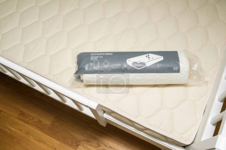 Photo for Paris, France - Oct 27, 2022:An overhead view of a new bed installation in a childs room, featuring the SOTNATFJARIL Waterproof Mattress Protector, size 90x200 cm - Royalty Free Image