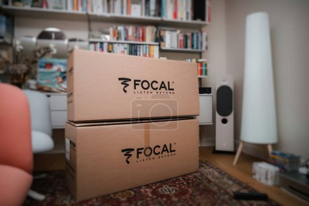 Photo for Paris, France - Nov 15, 2023: An overhead view of hands unboxing Focal loudspeakers, revealing accessories like a key, cleaning cloths, and the Chora line manual - Royalty Free Image