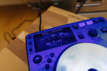 Photo for Paris, France - Oct 24, 2023:A close-up view of unboxing the new Denon DN-S100 DJing equipment with a captivating blue color cast on the device, setting the stage for an exciting DJ experience - Royalty Free Image
