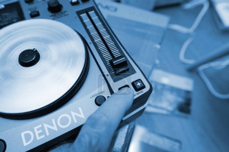 Photo for Paris, France - Oct 24, 2023: Observe a skilled hand expertly pressing the pitch bend button on the Denon mixing unit, showcasing precise control and artistry in DJing - Royalty Free Image