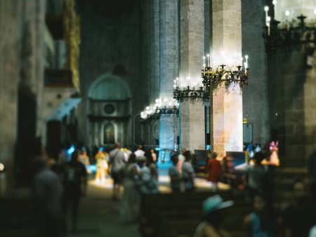 Photo for A group of unrecognizable people standing around the Catedral-Baslica de Santa Mara in Palma de Mallorca, Spain tilt-shift lens used - Royalty Free Image