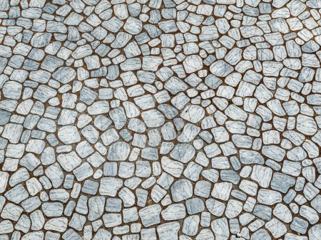 Photo for Close-up view of an intricate cobblestone pattern creating a durable and aesthetic ground surface. - Royalty Free Image