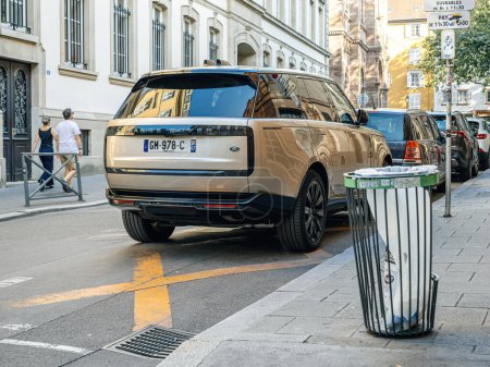 Foto de Estrasburgo, Francia - 2 de julio de 2023: Un híbrido eléctrico de color champán Range Rover estacionado junto a la calle habla del lujo urbano y el transporte moderno en un bullicioso paisaje urbano - Imagen libre de derechos