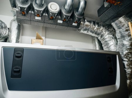 Photo for A high-tech central heating ventilation system installed in a clean modern basement. - Royalty Free Image