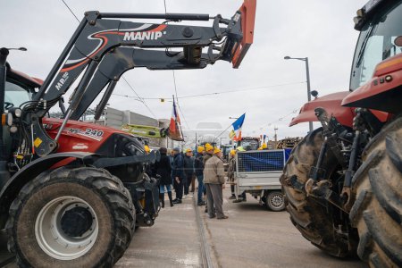 Photo for Strasbourg, France - Feb 6, 2024: Group of adult and senior farmers with tractors block European Parliament entrance, protesting against imported food with lower standards and new GMOs. - Royalty Free Image