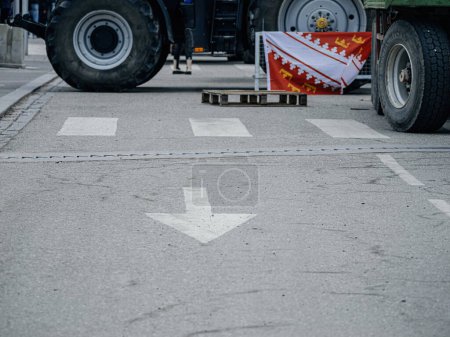 Photo for Strasbourg, France - Feb 6, 2024: Protesters with tractors block entrance to European Parliament, obstructing street signage. Protest against imported food with lower standards and new GMOs - Royalty Free Image