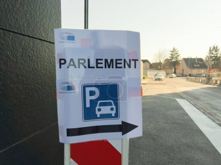 Photo for Strasbourg, France - Mar 4, 2022: View from the street of parking signage direction arrow to the Parliament at the European Parliament building - Royalty Free Image
