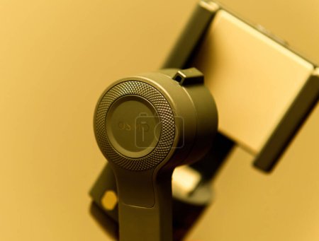 Photo for Paris, France - Aug 16, 2019: new dji osmo stabilizer gimbal on a yellow background usefeul tool for movbile chimmatography - Royalty Free Image