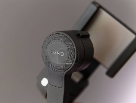 Photo for Paris, France - Aug 16, 2019: Showcase the hero object, the DJI Osmo, against a sleek gray background, perfect for stabilizing smartphone footage on both iOS and Android platforms. - Royalty Free Image