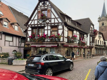 Photo for Obernai, France - Dec 26, 2023: Obernais historic center, with cobblestone streets and timbered houses, while discovering Rugrassff stores exquisite lingerie - Royalty Free Image