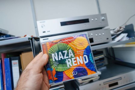 Photo for Paris, France - Dec 28, 2023: A male hand proudly presents the new SACD, NAZARENO featuring compositions by Leonard Bernstein, Igor Stravinsky, and Osvaldo Golijov, conducted by Sir Simon Rattle with - Royalty Free Image